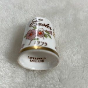 Hand painted ceramic thimble dated Easter 1979. Gold  ribbon and floral motifs.